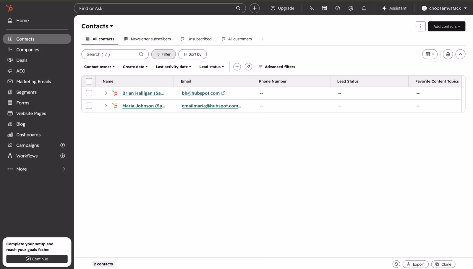 HubSpot CRM Contacts view showing the all-contacts table with name, email, phone, lead status and content-topic columns, plus filtering and sorting controls